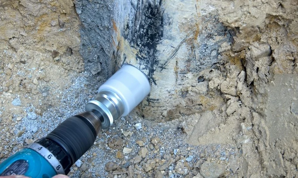 Drilling a hole into a hard surface with a hole saw