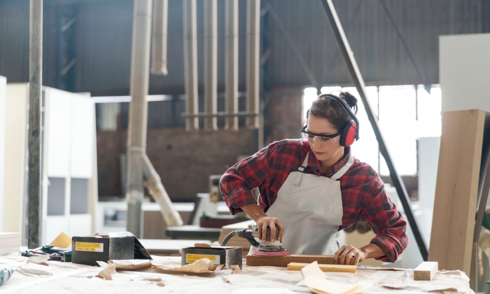 A female woodworker confident in her craft