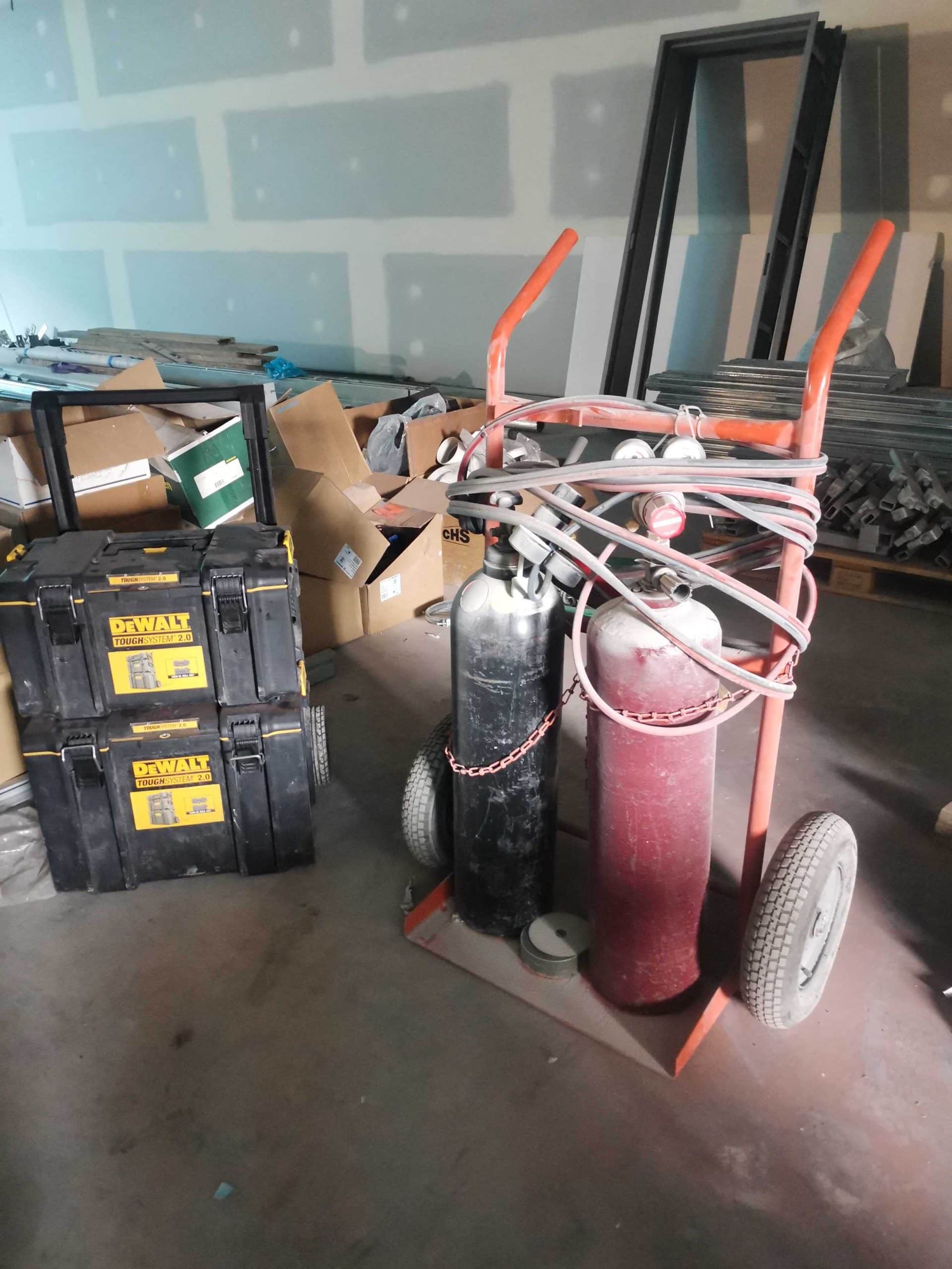 Wrapped oxyacetylene tanks in a trolly cart and DeWalt sturdy tool box
